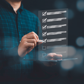 Person writing a checklist on a screen