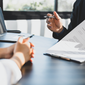 Men across board room table negotiating