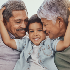 Grandparents being embraced by grandson