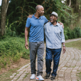 Adult man walking with elderly father